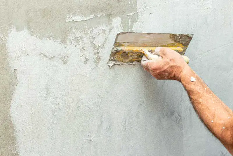 lime plaster being applied with a steel plastering trowel