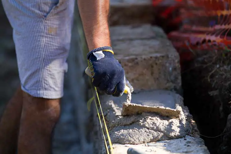 bricklayer-using-lime-mortar-to-lay-bricks